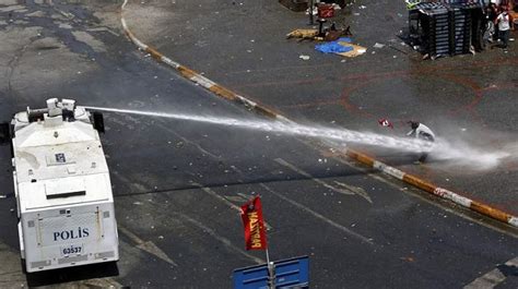 Protesters Take Cover From Water Cannon In Istanbuls Taksim Square