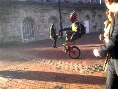 This guy is completely insane. Awesome BMX Wheelie (No Front Wheel!) - YouTube