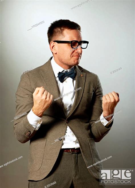 Confident Nerd In Eyeglasses And Bow Tie Enjoying Success Stock Photo