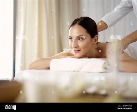 Pretty Brunette Woman Enjoying Procedure Of Back Massage In Spa Salon Beauty Concept Stock