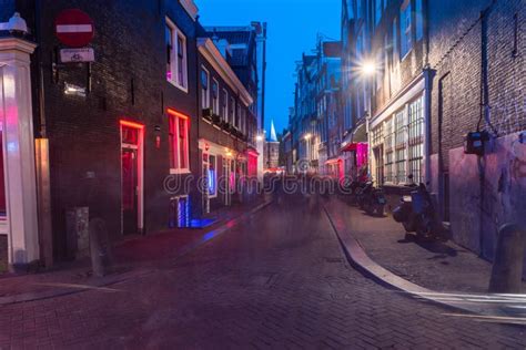 amsterdam netherlands june 6 2019 red light district with red and blue lights windows in de