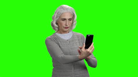 Old Woman Taking Selfie On Green Screen Aged Caucasian Woman Using