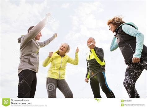 Senior Runners Outdoors Resting Hands In The Air Stock Photo Image
