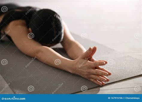 Young Woman Practicing Extended Child`s Asana In Yoga Studio Utthita