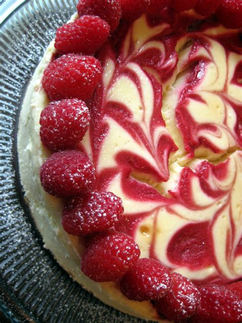 This cheesecake with raspberry sauce is the most decadent, tasty dessert. Raspberry Swirl Cheesecake | A Hint of Honey