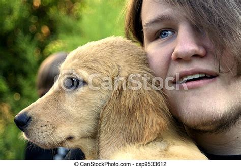 Teen Boy And Golden Puppy 1 Closeup Of A Smiling Teenage Boy With His