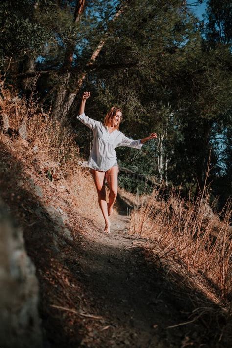 Barefoot Woman Walking And Dancing Along Narrow Path In Nature Stock