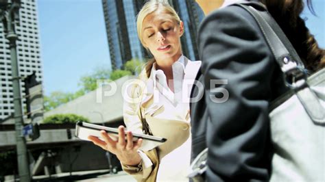 Successful American Businesswomen Discussing Business Strategy On Tablet Stock Footage