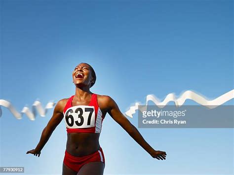 Runner Crossing Finish Line Photos And Premium High Res Pictures