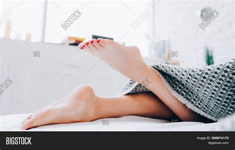 Foot Hygiene Barefoot Woman Lying Bed Beautiful Legs Peeking Out Playfully From Blanket Image