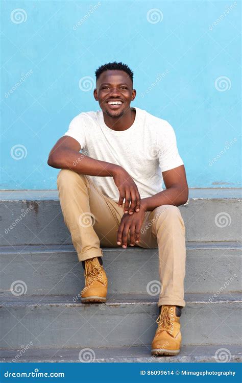 Stylish Young Man Sitting On Steps And Smiling Stock Photo Image Of