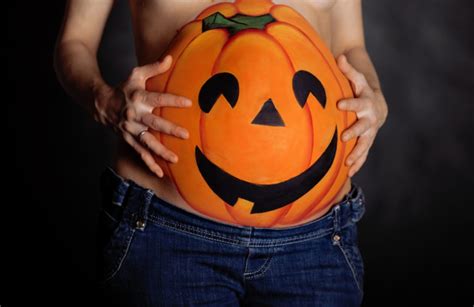 Halloween Pumpkin Painted On Belly Of Pregnant Piedmont Doulas