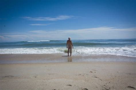 Rear View Of Nude Man On Beach Against Sky Id