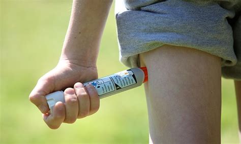 Picture Shows A Boy Using An Epipen In His Thigh Demonstrating What To