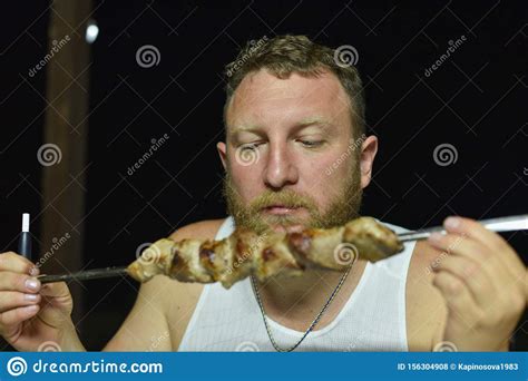 Bearded Man Eats Delicious Barbecue A Man With A Red Beard Eats