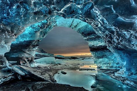 Icelandic Ice Cave In Skaftafell With Blue Ice And Volcanic Ash