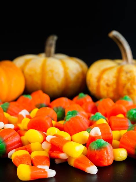 Premium Photo Halloween Candy Corn And Pumpkin Candies On Black