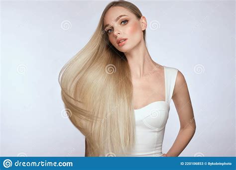Beautiful Blond Girl With A Perfectly Smooth Hair And Classic Make Up