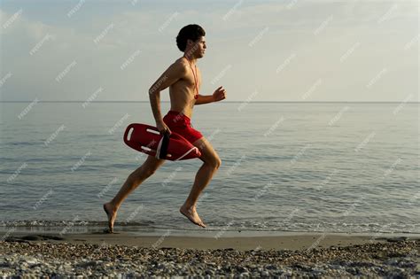 Premium Photo Lifeguard Running On Beach Side View