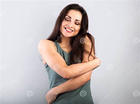 Happy Toothy Smiling Sporty Woman Hugging Herself With Natural Emotional Enjoying Face On Light