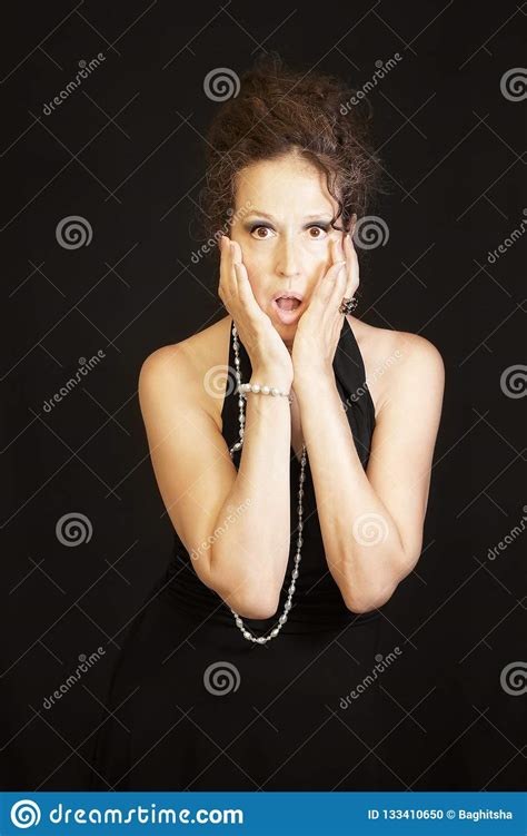 Shocked Sophisticated Mature Woman Wearing Black Dress Stock Photo