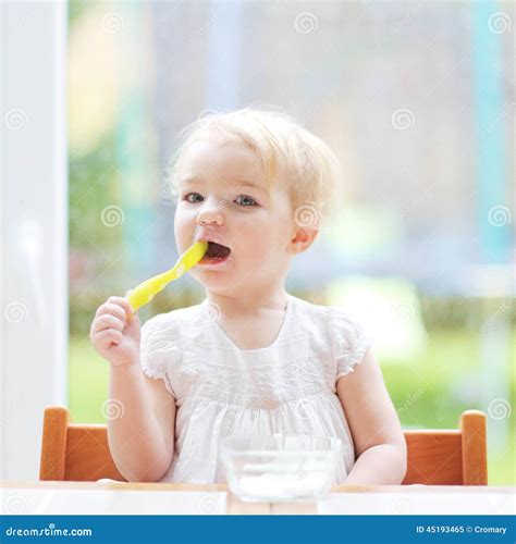 Cute Baby Girl Eating Yogurt From Spoon Stock Image Image Of Girl