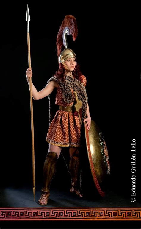 A Woman Dressed In Roman Costume Holding A Spear And Shield
