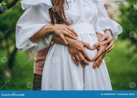 Happy Pregnancy In Adulthood A Man Gently Hugs The Belly Of His Pregnant Wife Stock Image