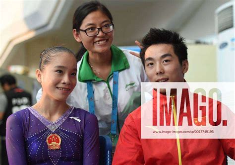 A Volunteer C Poses With Chinese Gymnasts Yao Jinnan L And You Hao