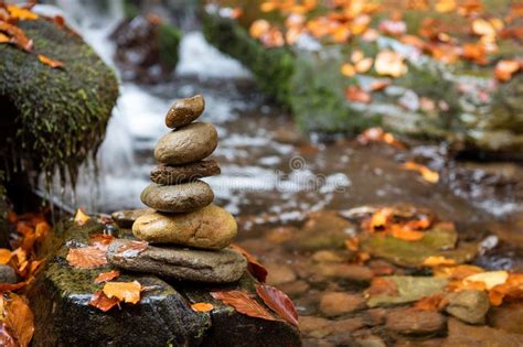 Colorful Majestic Waterfall And Zen Stones In Autumn Forest Stock Photo