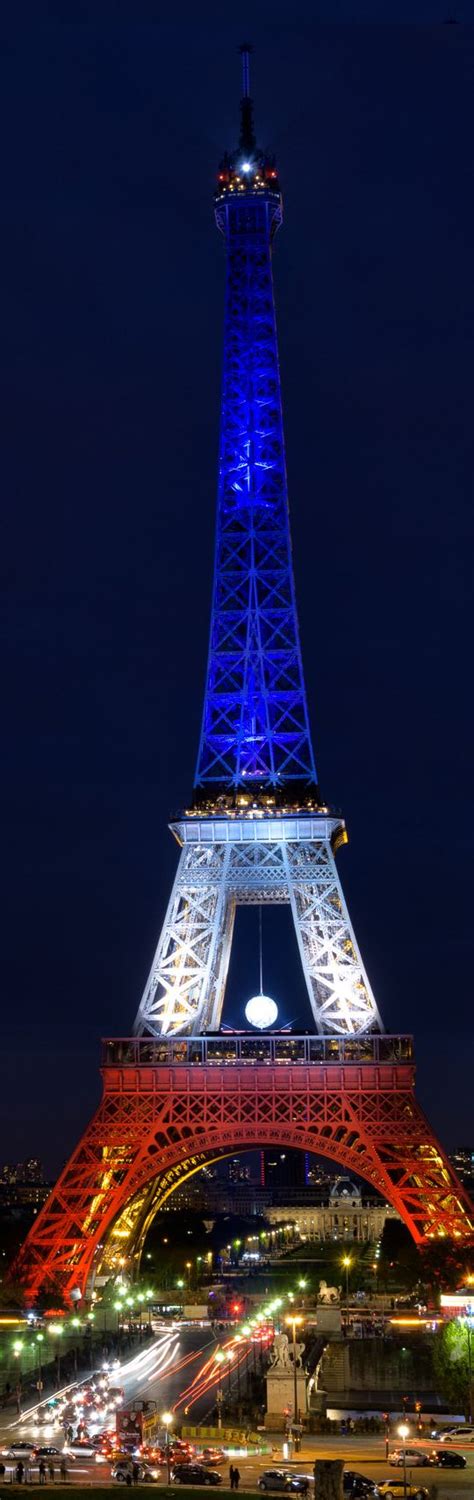 The eiffel tower is an iron lattice tower located on the champ de mars in paris. France | Paris | The Eiffel tower illuminated with the ...