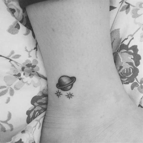 Ankle Tattoo Of Planet Saturn Together With Two Stars
