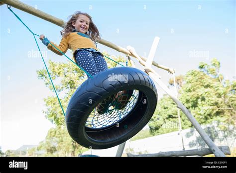 Girl Playing On Tire Swing Photo Stock Alamy