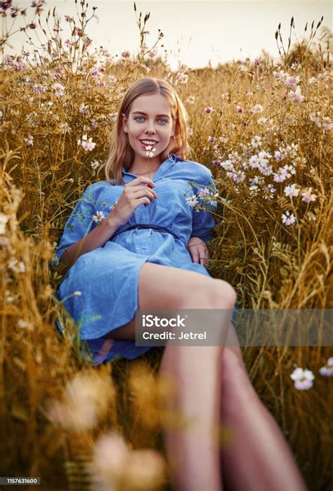 Smiling Beautiful Girl Lying Among Grass And Flowers Outdoor Portrait