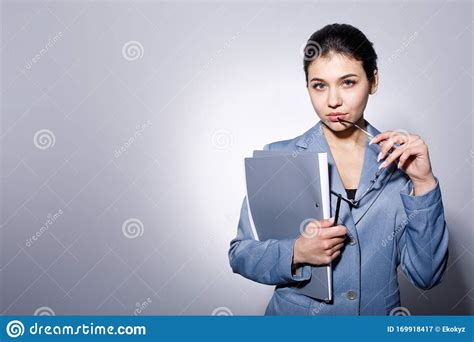 Female White Collar Touching Her Lip With Glasses Temple Stock Image