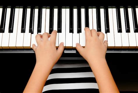 Premium Photo Hands Of Kid Playing Piano