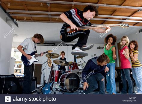 Group Of Teenagers Playing Music In Garage Band Stock Photo Royalty