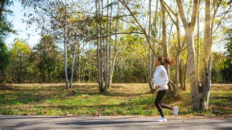 A Woman Jogging In City Park In The Morning Stock Image Image Of Girl