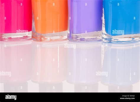 Four Multi Colored Bright Nail Polish With Reflection Stock Photo Alamy