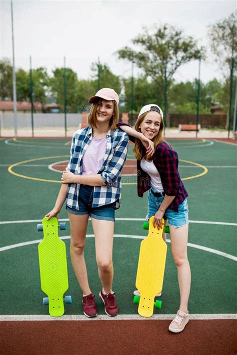 A Pretty Smiling Blond Girl Wearing Checkered Shirt White Cap And