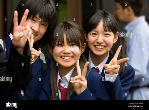 Japanese School Girls Giving The Peace Symbol Stock Photo
