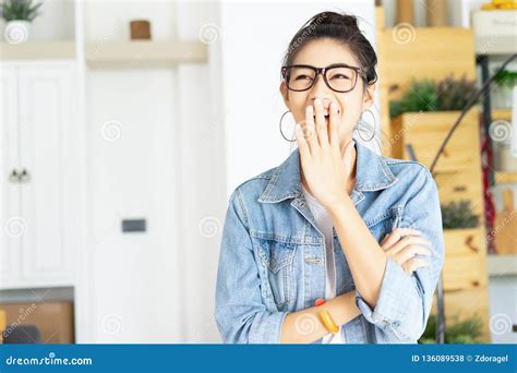 Portrait Of Cheerful Asian Woman Laughing Covering Her Mouth With A