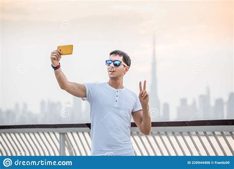 Male Traveler Takes A Selfie On His Smartphone Against The Backdrop Of