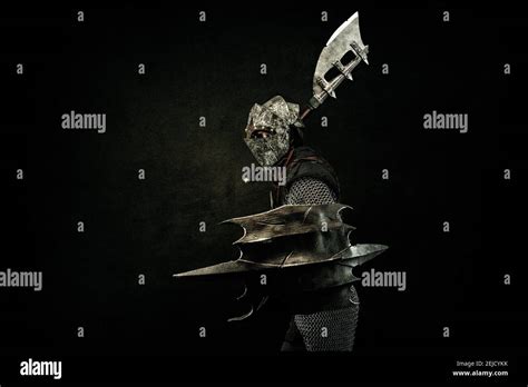 Medieval Fighter In Armor In Profile Carrying A Shield And An Ax On