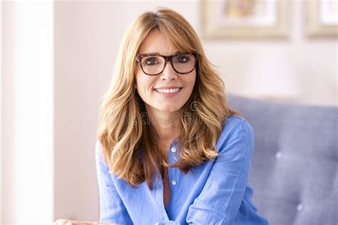 Portrait Of Attractive Middle Aged Woman Looking At Camera And Smiling