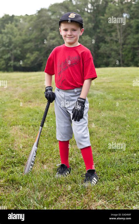 Little Boy Dressed Ina Baseball Uniform With A Baseball Glove Ready