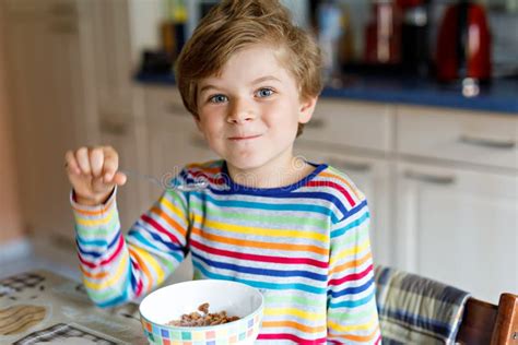 Happy Little Blond Kid Boy Eating Cereals For Breakfast Or Lunch