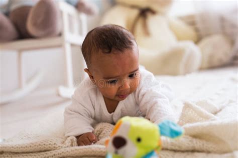 Adorable African American Baby Boy Playing With Toy Indoors Stock Photo
