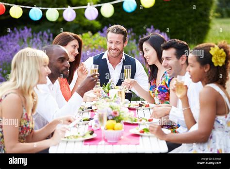 Group Of Friends Enjoying Outdoor Dinner Party Stock Photo Alamy