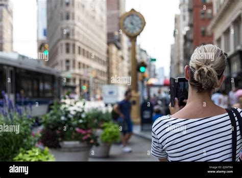A Blonde Woman Shooting Flatiron Building With Her Smartphone Hi Res